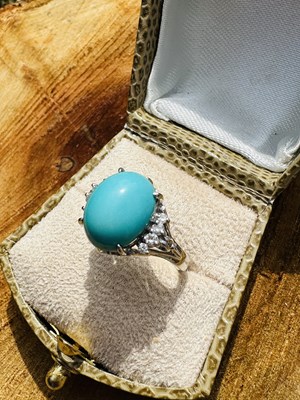 Lot 1105 - A turquoise and diamond dress ring, centred...