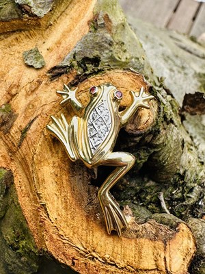 Lot 1111 - A diamond and ruby frog brooch, realistically...