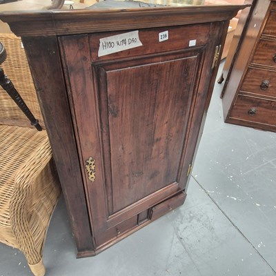 Lot 236 - A Georgian fruitwood corner cupboard, the...
