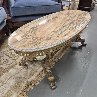 Lot 336 - A marble topped gilt metal coffee table, the...