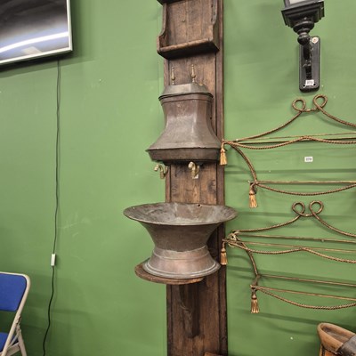 Lot 372 - A Continental copper and brass lavabo mounted...