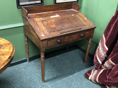 Lot 270 - An antique elm clerk's desk, the galleried top...