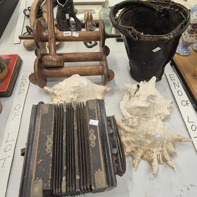 Lot 835 - A leather fire bucket, three conch shells, a...