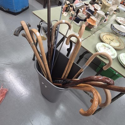 Lot 841 - A collection of walking sticks, a shooting...