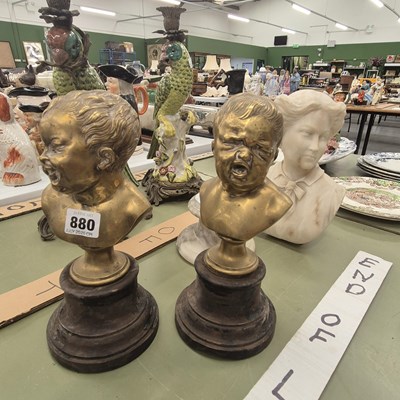 Lot 880 - A pair of polished bronze heads of babies...