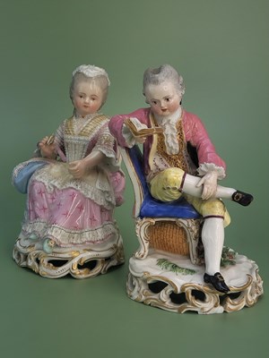 Lot 1597 - A pair of Meissen lace trimmed seated figures,...