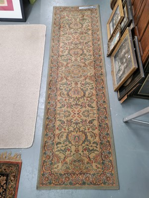 Lot 438 - A machine made runner of Persian design 252 ×...
