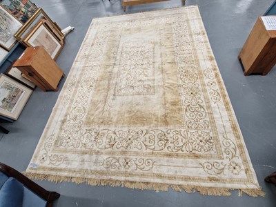 Lot 443 - A machine made carpet of Neoclassical design...