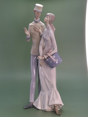 Lot 1804 - A Lladro couple, he wears a uniform and she...