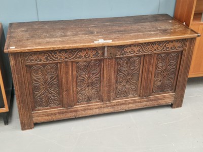 Lot 8 - An antique oak coffer with a carved four panel...