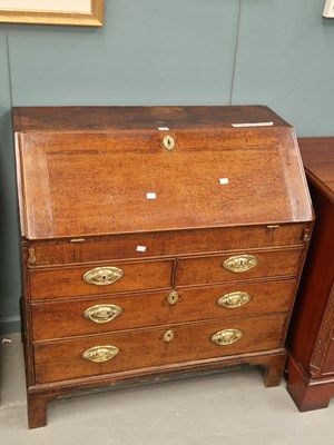 Lot 19 - A Georgian oak bureau, the fitted and welled...