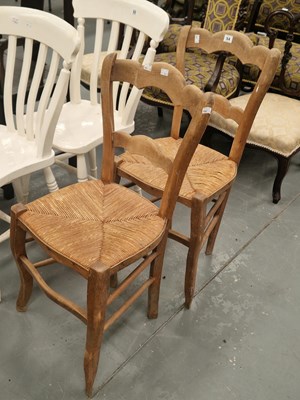 Lot 54 - A pair of French beech kitchen chairs, the...