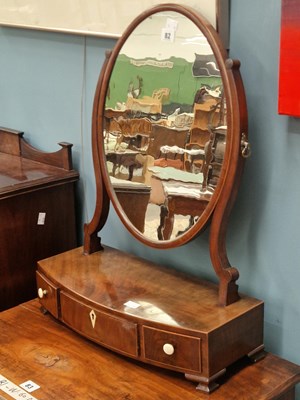 Lot 82 - A 19th century mahogany oval swing mirror with...