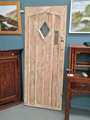 Lot 93 - An antique stripped pine door with gothic...