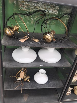 Lot 515 - A pair of brass oil lamps in iron ceiling...