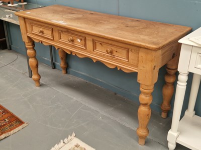 Lot 104 - A vintage pitch pine side table of three...