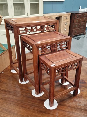Lot 117 - A Chinese hardwood nest of three tables,...