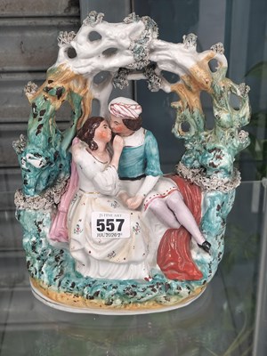 Lot 557 - A Staffordshire pottery arbour group of lovers