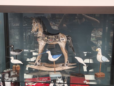 Lot 558 - A carved wood miniature rocking horse together...