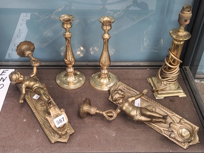 Lot 567 - A pair of brass wall lights held up by putti,...