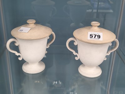 Lot 579 - A pair of Wedgwood biscuit pottery two handled...
