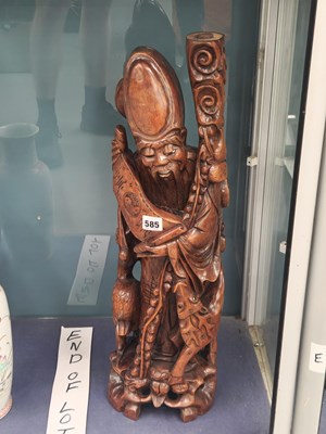 Lot 585 - A carved wood figure of Shoulao, his staff tip...
