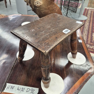 Lot 168 - An small antique oak stool, the slab top on...