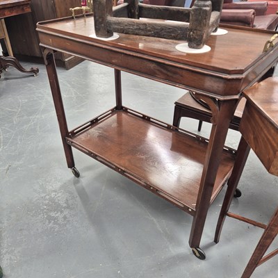 Lot 174 - An Edwardian mahogany tea trolley with a...