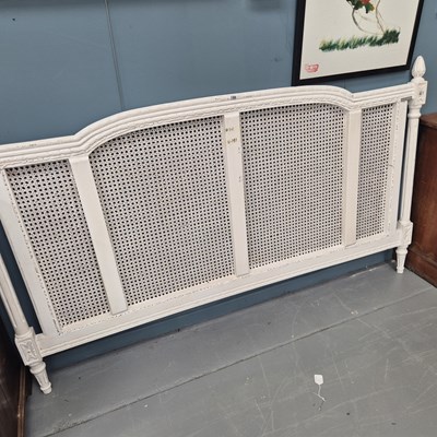 Lot 195 - A painted carved wood and cane double bed head...