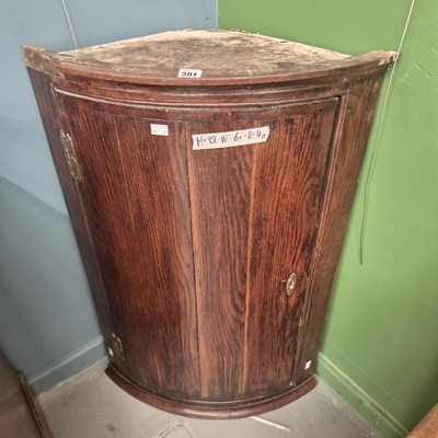 Lot 201 - A Georgian oak bow front corner cabinet H 88 W...