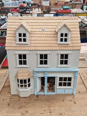 Lot 650 - A shingle roofed three storey doll's house...