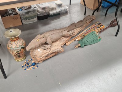 Lot 694 - A carved wood crocodile, a fan, two parasols...