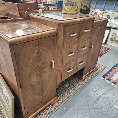 Lot 254 - An Art Deco walnut sideboard, the three...