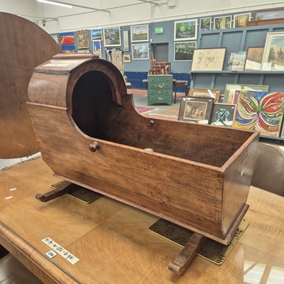 Lot 255 - An antique mahogany domed hood rocking cradle...