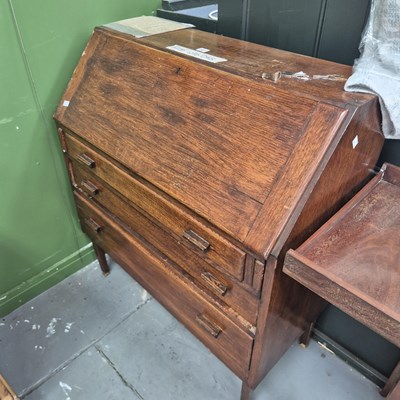 Lot 307 - A 20th century oak bureau of three drawers on...