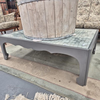 Lot 317 - A modern coffee table, the fabric under glass...