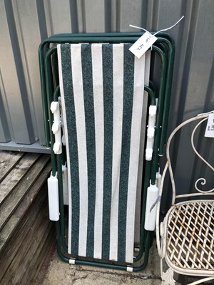 Lot 452 - A pair of tubular metal fold-out sun loungers...