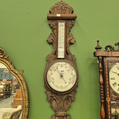 Lot 323 - An antique aneroid banjo barometer with a...