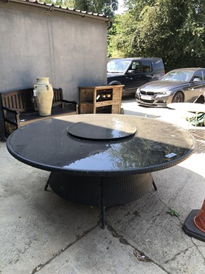 Lot 464 - A large, circular rattan-effect garden dining...