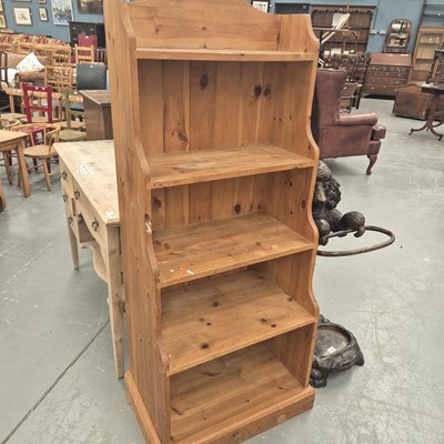 Lot 330 - A vintage pine waterfall bookcase on a plinth...