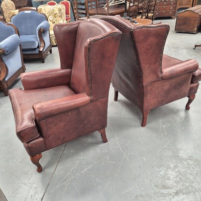 Lot 336 - A pair of 20th century wing back arm chairs in...