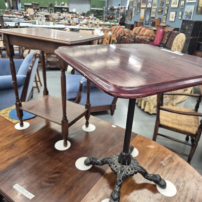 Lot 338 - A cast iron based cafe table with a hardwood...