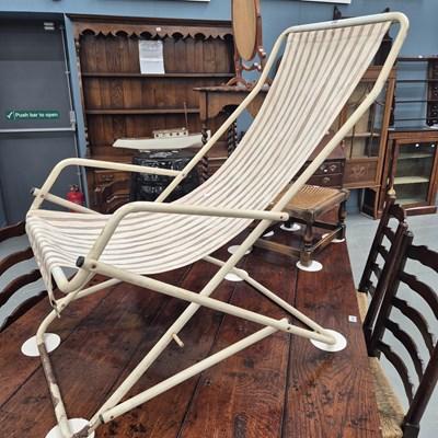 Lot 340 - A vintage tubular metal folding deck chair in...