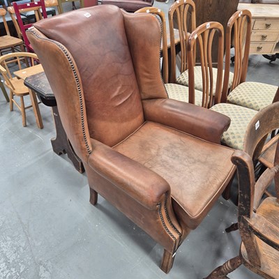 Lot 352 - A Georgian style brown leather wing back arm...