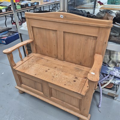 Lot 358 - A vintage pine panelled box settle on turned...