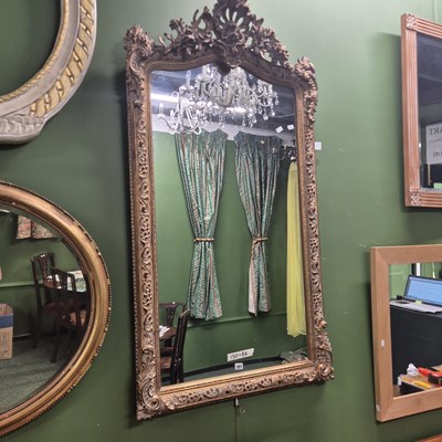 Lot 397 - A 20th century ornate gilt mirror with a...