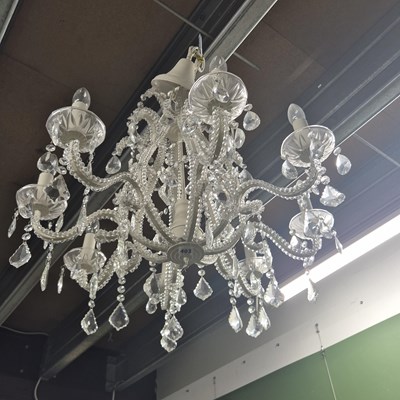 Lot 403 - A large glass and metal eight arm chandelier...