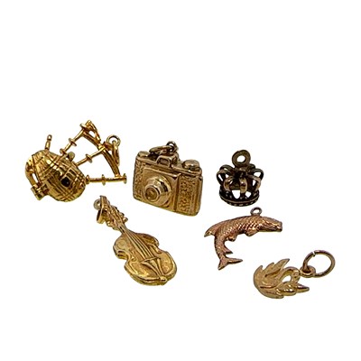 Lot 59 - A group of six gold charms comprising; a fish,...