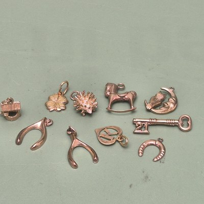Lot 60 - A group of gold charms to include a wishing...