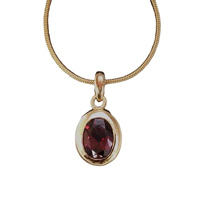 Lot 61 - An oval garnet pendant in a rub-over setting...